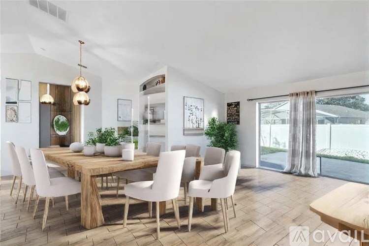 A modern dining room with a wooden table and white chairs.
