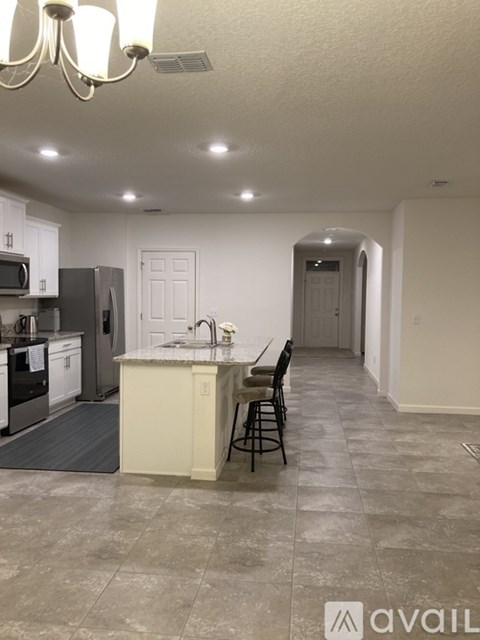 A kitchen with a counter and a sink.