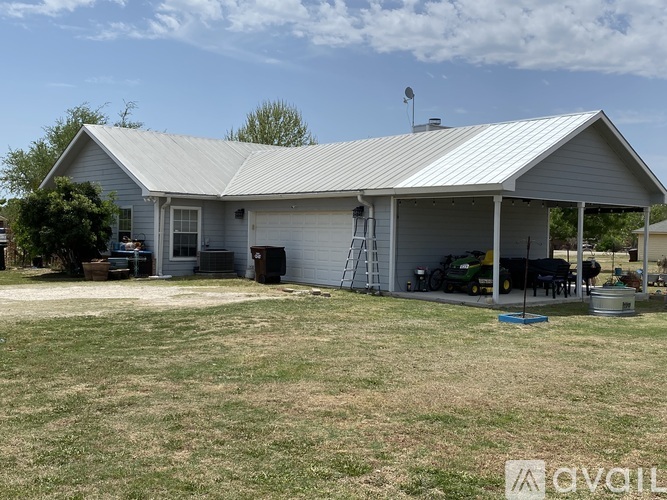 A house with a metal roof and a covered patio area.