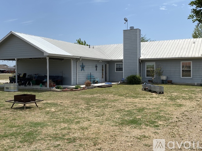 A house with a white roof and a covered patio area.