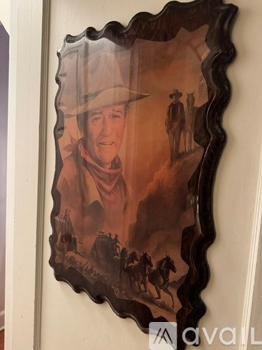 A framed picture of a man in a cowboy hat.