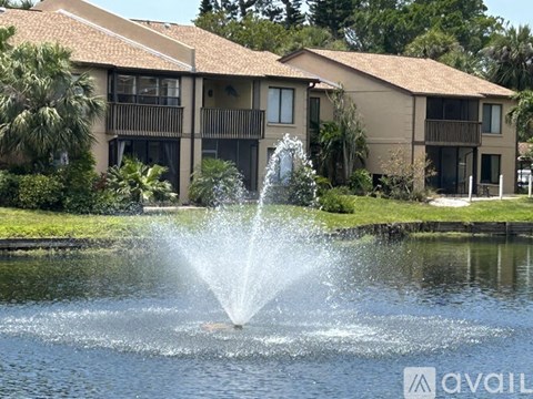 A fountain in the foreground with a building in the background.