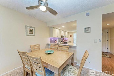 A dining room with a wooden table and chairs.
