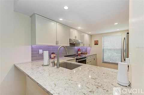 A kitchen with granite countertops and a modern design.