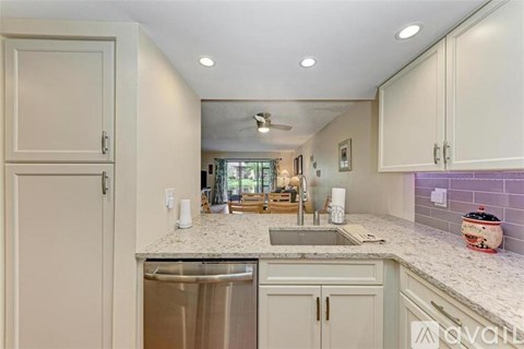 A kitchen with a sink and a dishwasher.
