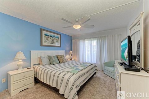 A bedroom with a bed, dresser, and television.