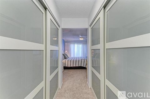 A bedroom with a bed and a window with curtains.