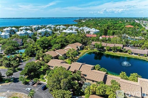 A bird's eye view of a resort with a pool and a parking lot.