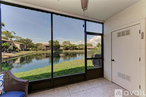 A balcony with a view of a lake and houses.