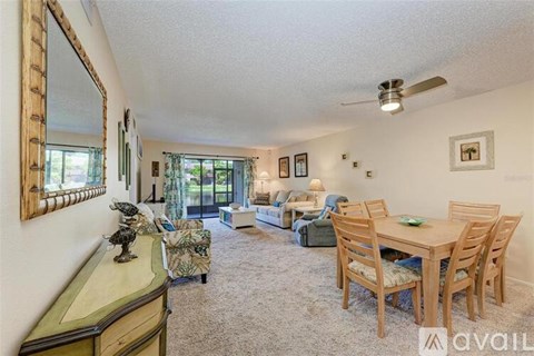 A living room with a dining table and chairs.