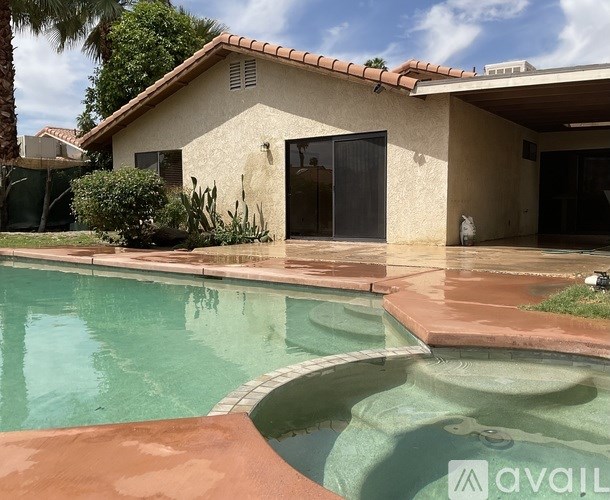 A house with a pool in front.