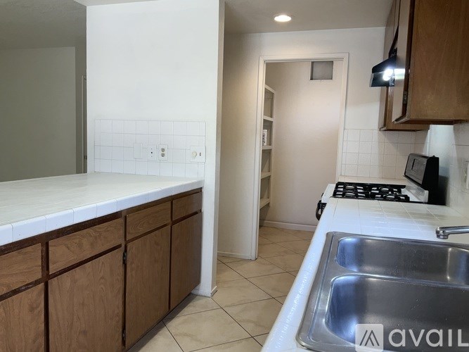 A kitchen with wooden cabinets and a white countertop.