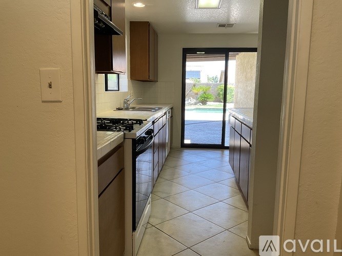 A kitchen with a black stove top oven and a black dishwasher.