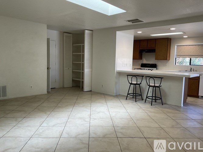 A kitchen area with a bar stool and a countertop.