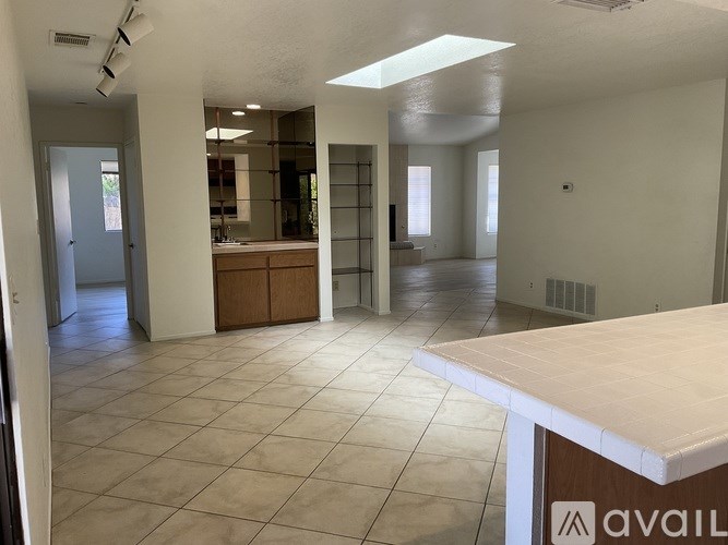 A spacious room with a kitchen area and a counter.