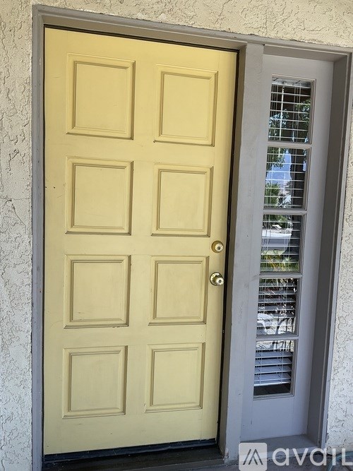 A yellow door with a silver handle is open.