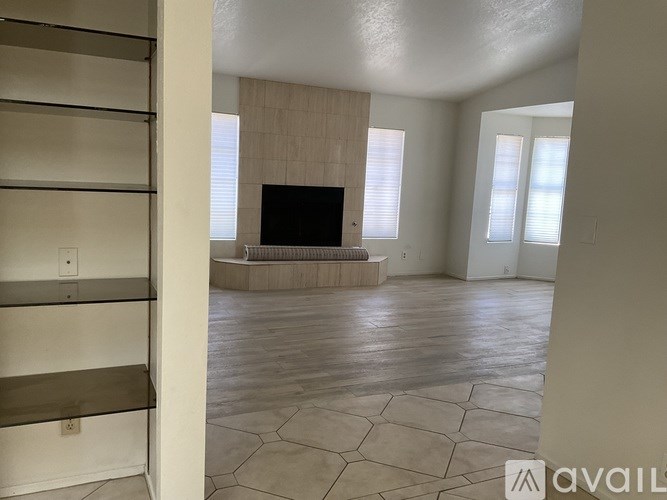 A living room with a television and a fireplace.