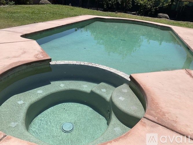 A pool with a drain in the middle of it.