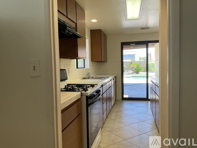 A kitchen with a stove top oven and a refrigerator.