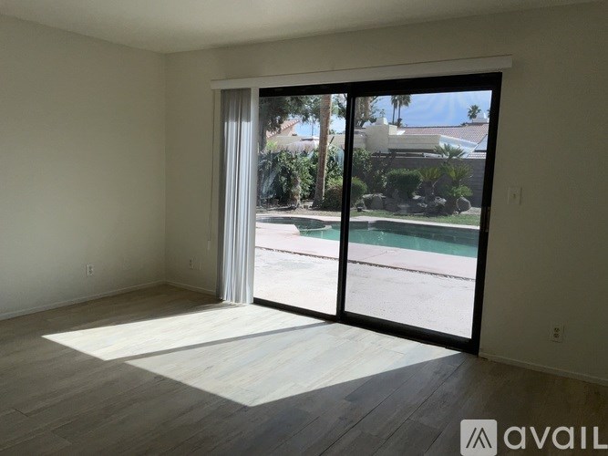 A room with a sliding glass door leading to a patio.