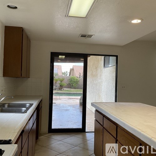 A kitchen with a sink and a counter top.