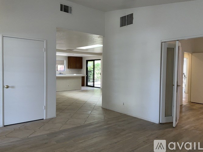 A spacious room with a door on the left and another door on the right.