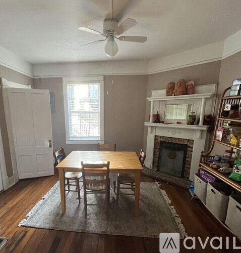 A dining room with a wooden table and chairs.