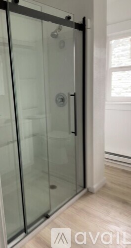 A glass door with a handle is in the foreground.