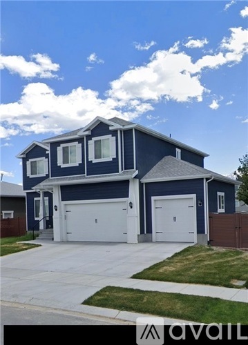 A blue house with a white garage door.