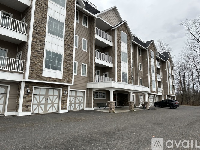 A large apartment building with multiple balconies and garage doors.