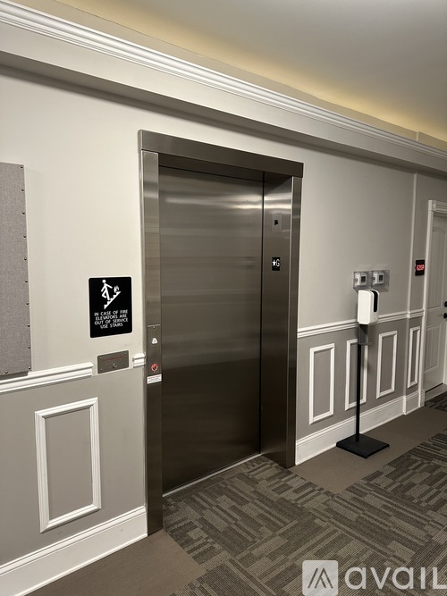An elevator with a sign on the wall next to it.