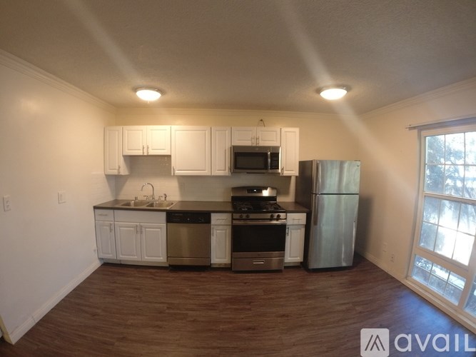 A kitchen with white cabinets and stainless steel appliances.