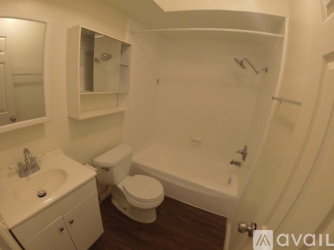 A bathroom with a toilet, sink, and bathtub.