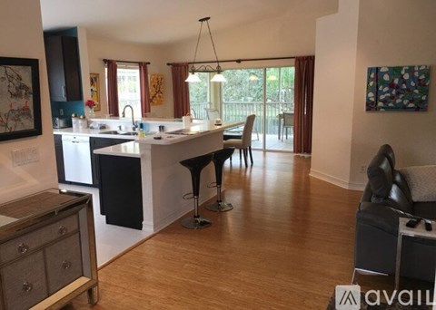 A kitchen with a table and chairs in the middle of the room.