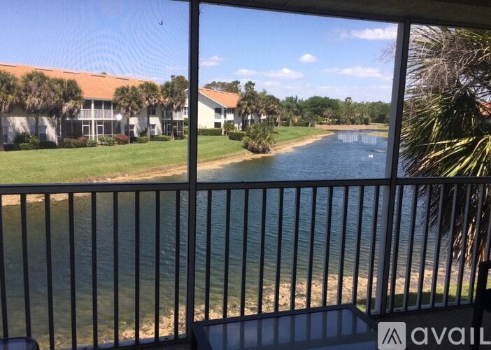 A view from a balcony overlooking a body of water and a building.