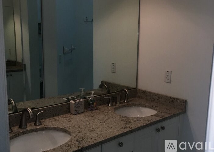 A bathroom with two sinks and a large mirror.