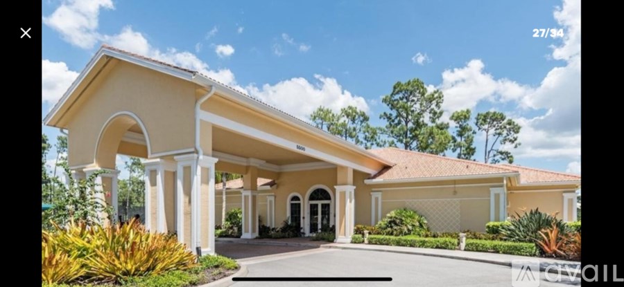 A house with a beige roof and white columns.