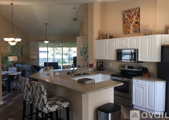 A kitchen with a bar area and a dining table.