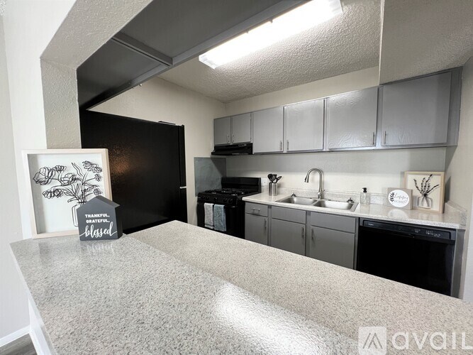A kitchen with a granite countertop and a sign that says "thankful".