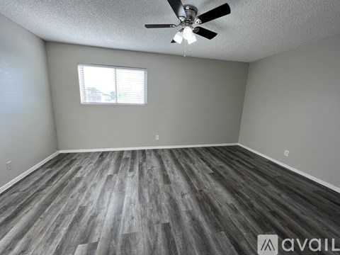A room with a ceiling fan and a window.