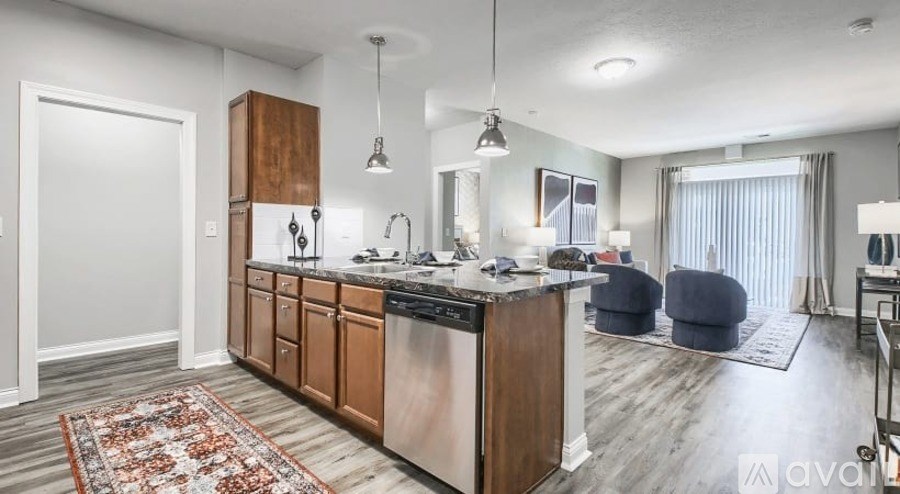 A kitchen with wooden cabinets and a rug on the floor.