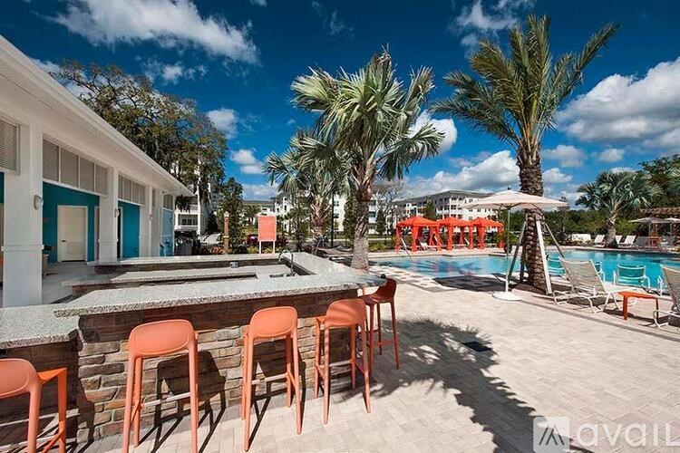 A poolside area with chairs and a bar.