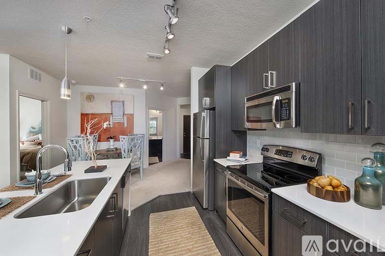 A kitchen with a sink, stove, and oven.