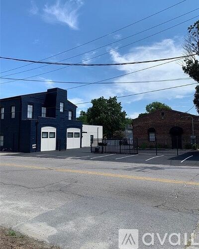 A blue building with a black gate in front of it.
