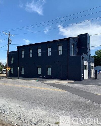 A black building with a yellow line in front of it.
