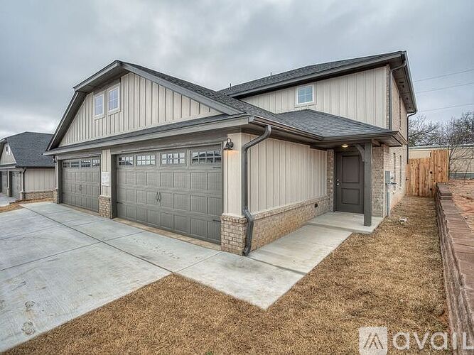 A two-story house with a garage is available for rent.