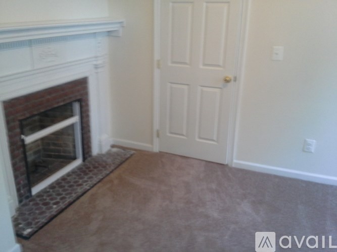 A room with a fireplace and a door.