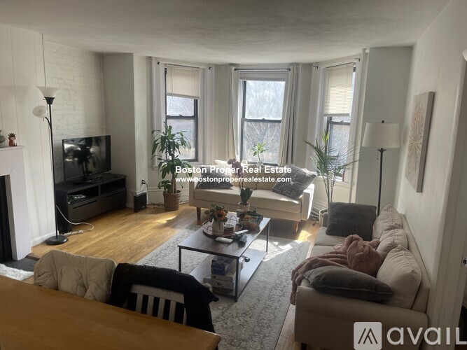 A living room with a fireplace and a television.