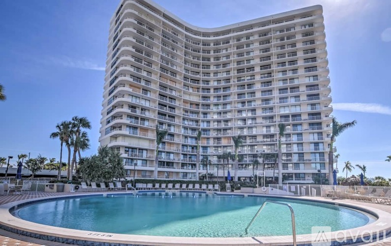 A large building with a pool in front of it.