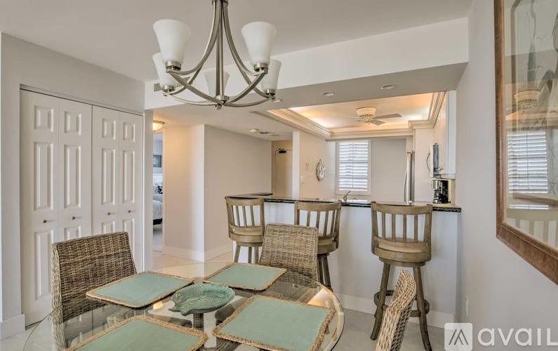 A dining room with a table set for four.